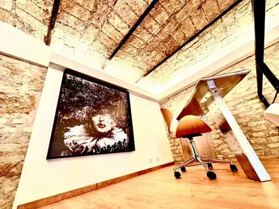 a room with a painting on the wall and a chair at Buonarroti Art Home - Luxury and Art in Rome in Rome