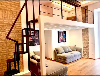 a living room with a loft bed and a couch at Buonarroti Art Home - Luxury and Art in Rome in Rome
