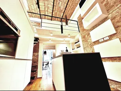 a loft kitchen with a exposed brick wall at Buonarroti Art Home - Luxury and Art in Rome in Rome