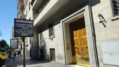 a building with a sign on the side of a street at Residenza in Rome