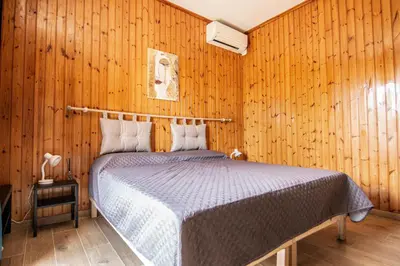 a bedroom with a bed in a wooden wall at Yourquadrarooms B&b in Rome