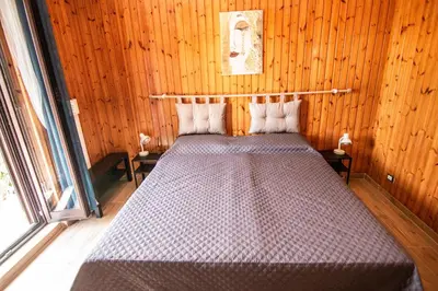 a bedroom with a bed in a wooden room at Yourquadrarooms B&b in Rome