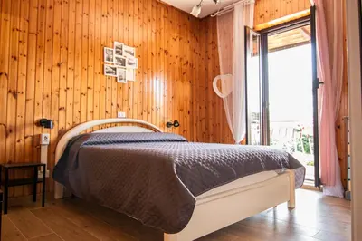 a bedroom with a bed and a wooden wall at Yourquadrarooms B&b in Rome