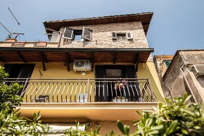 a building with a balcony with a person on it at Yourquadrarooms B&b in Rome