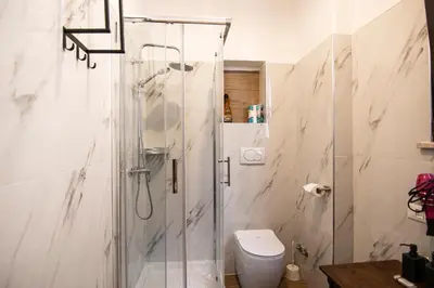 a bathroom with a shower and a toilet at Yourquadrarooms B&b in Rome
