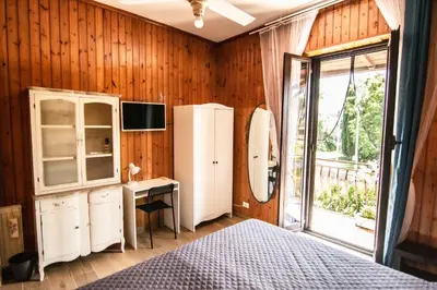 a bedroom with a bed and a desk and a refrigerator at Yourquadrarooms B&b in Rome