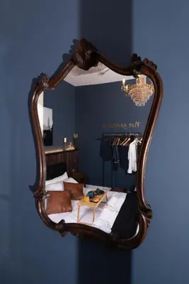 a mirror on a wall with a bed in a room at Loft stupendo nel cuore di Trastevere AcasadiCri in Rome