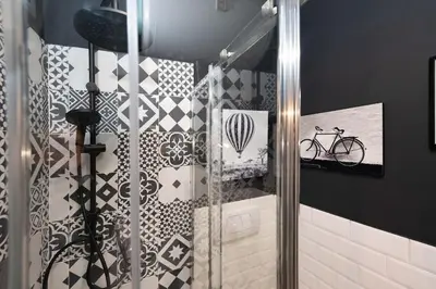 a bathroom with a shower with a bike on the wall at Loft stupendo nel cuore di Trastevere AcasadiCri in Rome