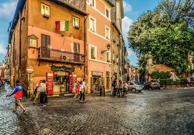 a group of people walking down a cobblestone street at Loft stupendo nel cuore di Trastevere AcasadiCri in Rome