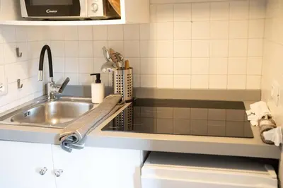 a kitchen with a sink and a counter top at Loft stupendo nel cuore di Trastevere AcasadiCri in Rome