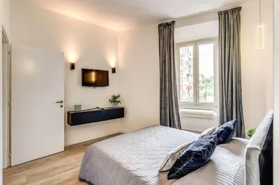 a bedroom with a bed and a window at Vatican Charming Home in Rome