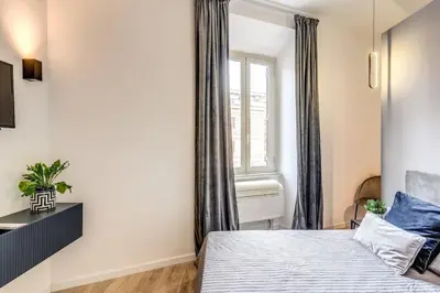 a bedroom with a bed and a window at Vatican Charming Home in Rome
