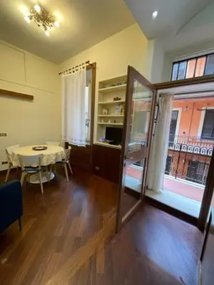 a living room with a table and a dining room at Colosseum Street in Rome