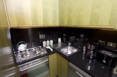 a small kitchen with a sink and a stove at Colosseum Street in Rome