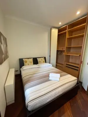 a small bedroom with a bed and a closet at Colosseum Street in Rome