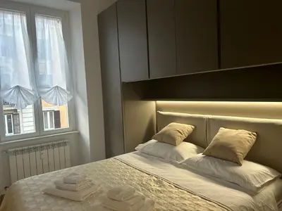 two stacks of towels sitting on top of a bed at Leonard Vatican House in Rome