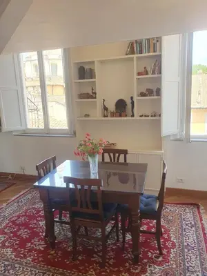 a dining room with a wooden table and chairs at coronari apartments 2 in Rome
