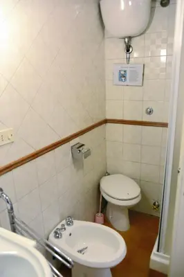 a small bathroom with a toilet and a sink at coronari apartments 2 in Rome