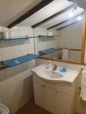 a bathroom with a sink and a mirror at coronari apartments 2 in Rome