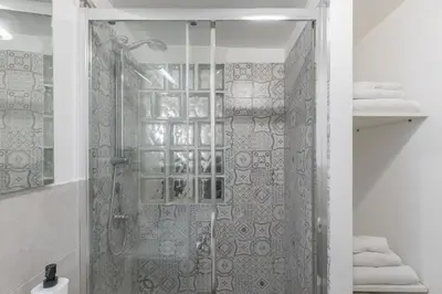a shower with a glass door in a bathroom at GuestHost - Comfy Studio x2 - Trastevere District! in Rome