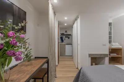 a bedroom with a table and flowers in a room at GuestHost - Comfy Studio x2 - Trastevere District! in Rome