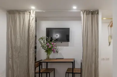 a vase of flowers on a table in a room at GuestHost - Comfy Studio x2 - Trastevere District! in Rome