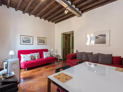 a living room with red couches and a table at Apartment Navona by Interhome in Rome