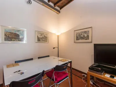 a room with a table and two chairs and a television at Apartment Navona by Interhome in Rome
