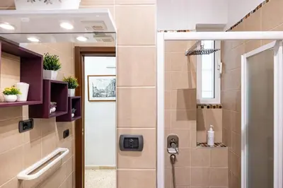 a shower with a glass door in a bathroom at Big Apartment Rome Air Conditioning WIFI Netflix 90 MQ in Rome