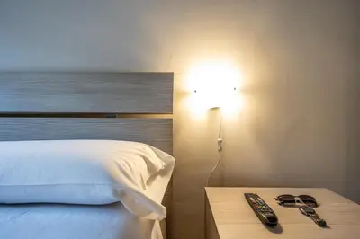 a bedroom with a bed and a table with remote controls at Big Apartment Rome Air Conditioning WIFI Netflix 90 MQ in Rome