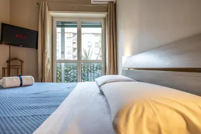 a bedroom with a large white bed with a window at Big Apartment Rome Air Conditioning WIFI Netflix 90 MQ in Rome