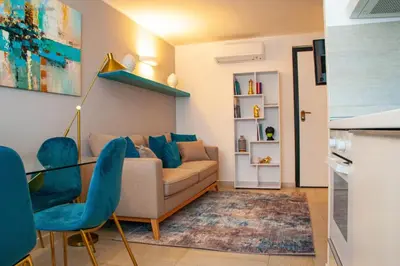 a living room with a couch and blue chairs at Algima Flat Roma Ponte Milvio in Rome