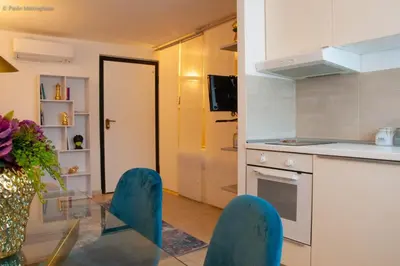 a kitchen with a glass table and chairs in a room at Algima Flat Roma Ponte Milvio in Rome