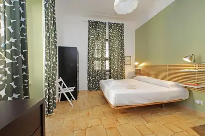 a bedroom with a bed and a desk and a television at Luxury Vatican White House in Rome