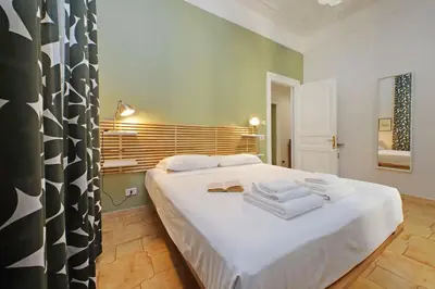 a bedroom with a white bed with towels on it at Luxury Vatican White House in Rome