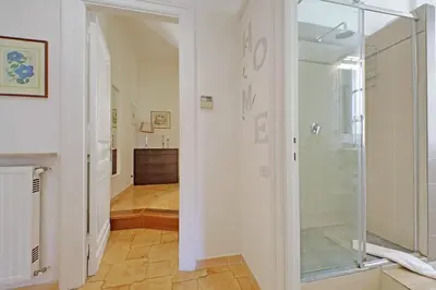 a hallway with a glass door leading to a room at Luxury Vatican White House in Rome