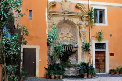 a fountain on the side of a building at Monti Charme - My Extra Home in Rome