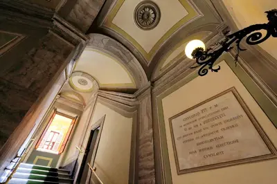 a building with a chandelier and a sign on the wall at Monti Charme - My Extra Home in Rome