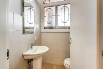a bathroom with a sink and a toilet at V E N E R E Apartments in Rome