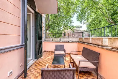 a patio with two chairs and a table on a balcony at V E N E R E Apartments in Rome