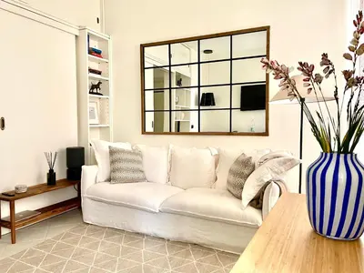 a living room with a white couch and a vase with flowers at Apartment in the heart of Rome in Rome