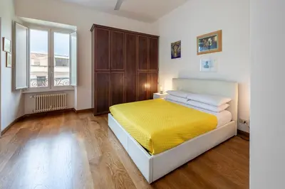 a bedroom with a bed and a large window at Quiet ApartmentTrastevere in Rome