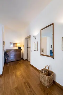 a living room with a mirror and a wooden floor at Quiet ApartmentTrastevere in Rome