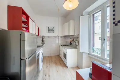 a kitchen with a stainless steel refrigerator and a window at Quiet ApartmentTrastevere in Rome