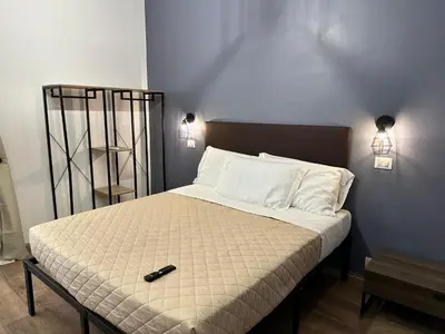 a bedroom with a bed with a remote control on it at Roma Chic Flats Policlinico Gemelli in Rome