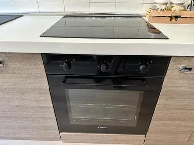 a black oven under a counter in a kitchen at Roma Chic Flats Policlinico Gemelli in Rome