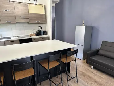 a kitchen with a counter and chairs in a room at Roma Chic Flats Policlinico Gemelli in Rome