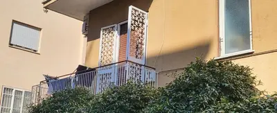 a balcony of a building with a window and bushes at Roma Chic Flats Policlinico Gemelli in Rome