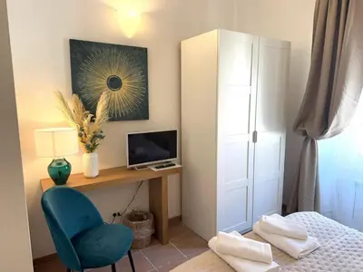 a bedroom with a desk with a computer and a bed at Aenea's B&B in Rome