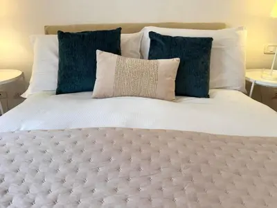 a large bed with blue pillows on top of it at Aenea's B&B in Rome